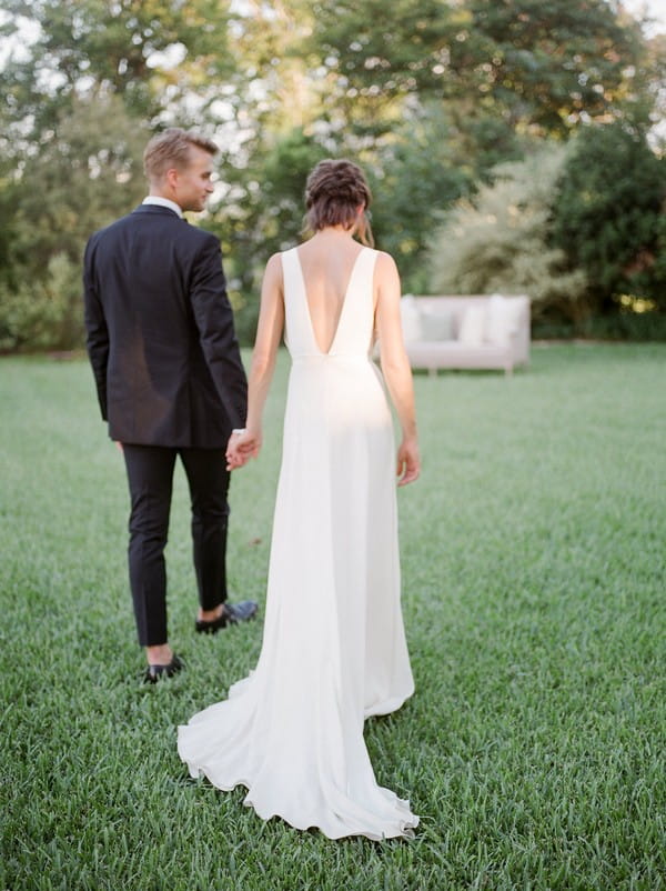 Bride and groom walking in garden of Barr Mansion in Austin, Texas