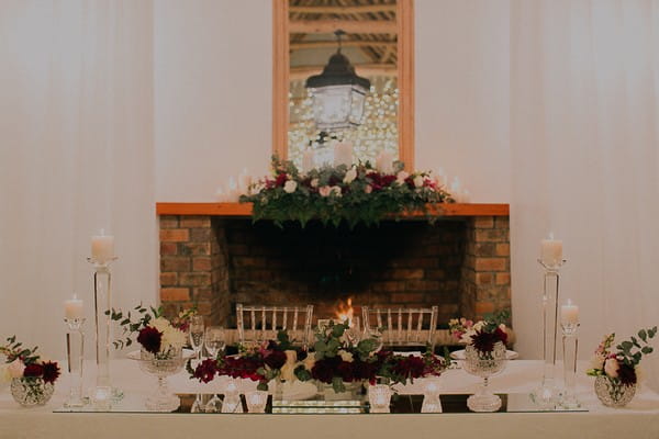 Wedding top table in front of fireplace