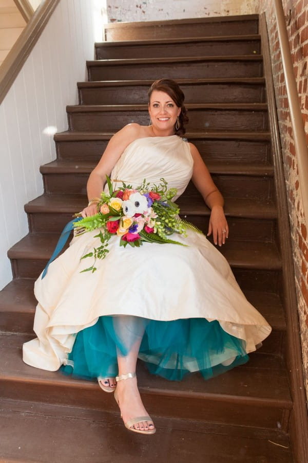 Bride leaning back on stairs