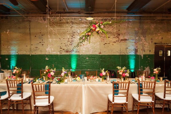 Wedding top table with hanging floral installation above