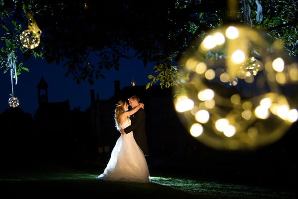 Bride and groom in garden of Brympton House at night