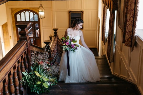 Bride on stairs at Brympton House