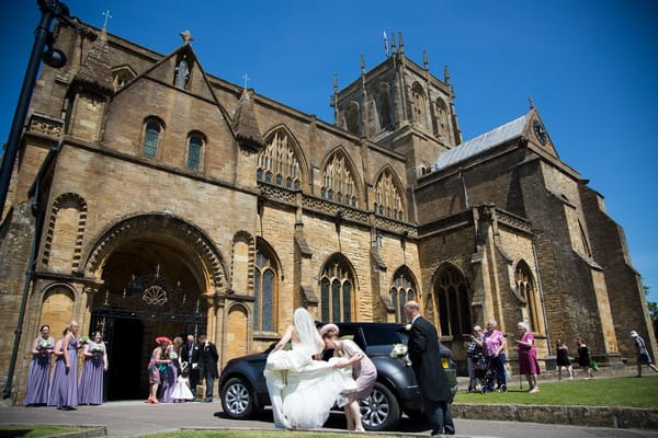 Bride arriving at Sherborne Abbey for wedding ceremony