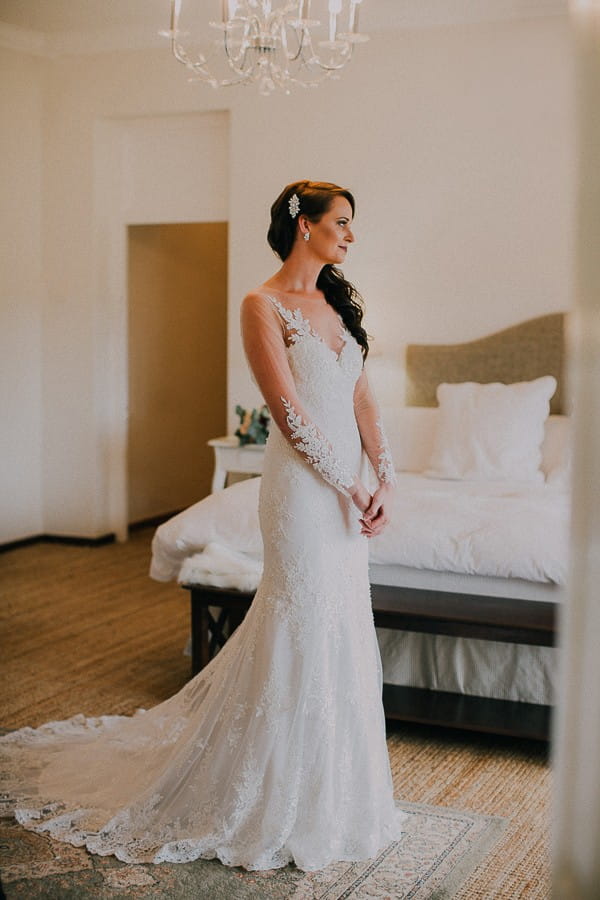 Bride standing in elegant lace wedding dress