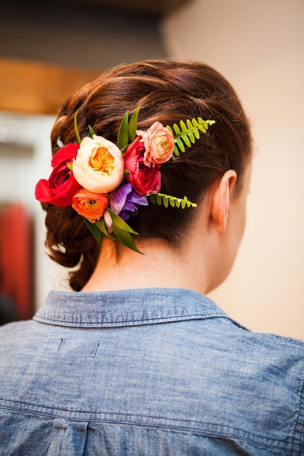 Colourful flowers in back of bride's hair