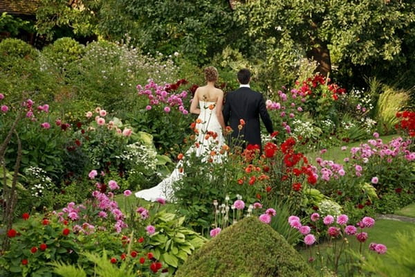 Bride and Groom Walking in Chenies Manor House Gardens