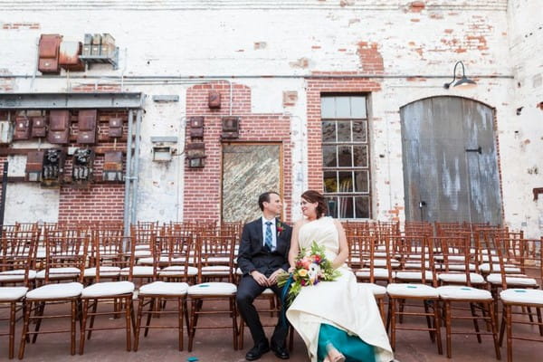 Bride and groom sitting on wedding ceremony chairs at The Engine Room in Georgia