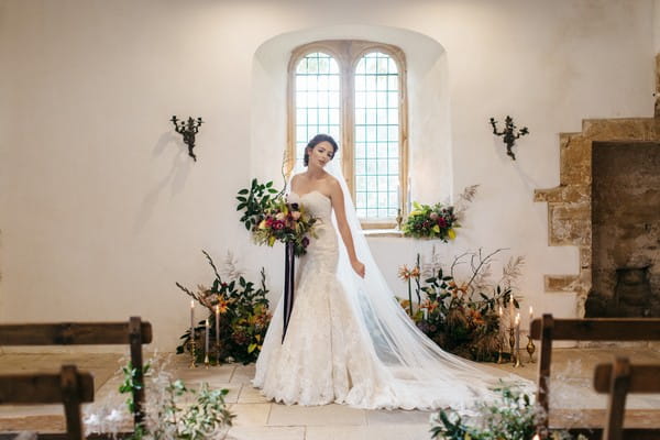 Bride holding bouquet in ceremony room at Brumpton House