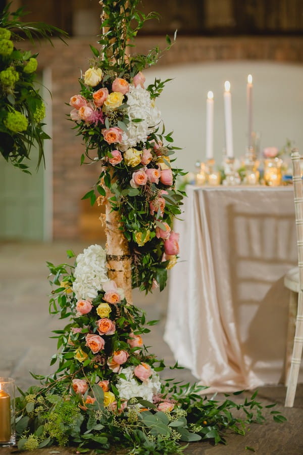 Floral and foliage display around post