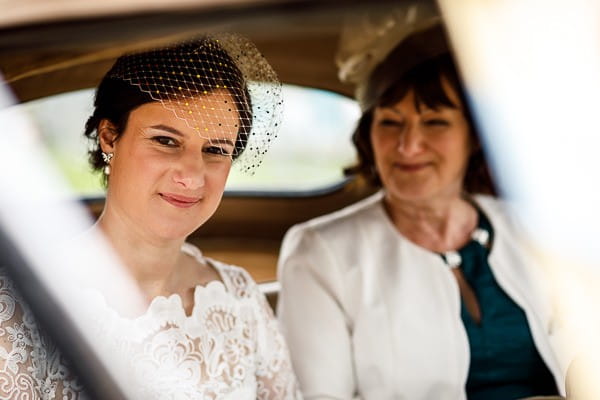 Bride and mother in back of wedding car