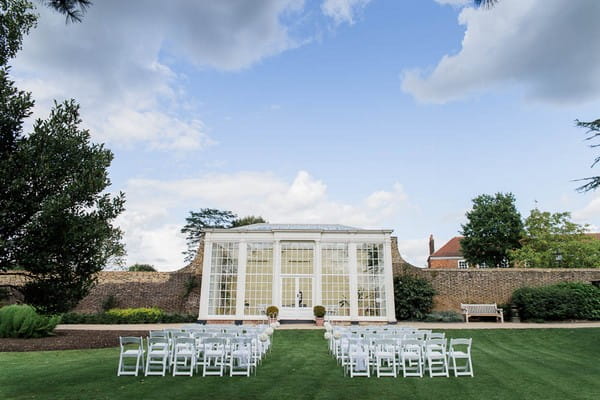 Wedding ceremony seating outside orangery at Langtons House