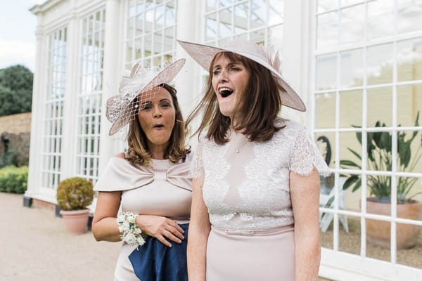 Women wearing hats at wedding