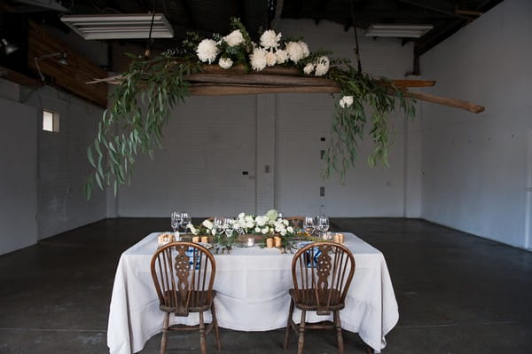 Hanging floral installation over wedding table