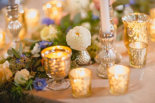 Votives, candles and flowers on wedding table