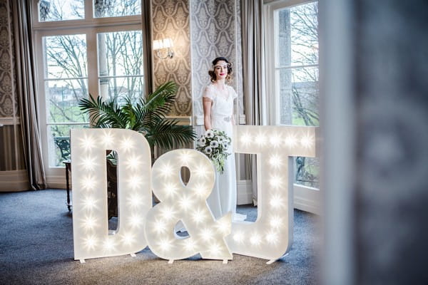 Bride behind illuminated letters