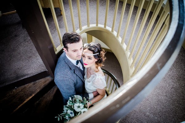 1920s bride and groom on spiral staircase at The Duke of Cornwall Hotel
