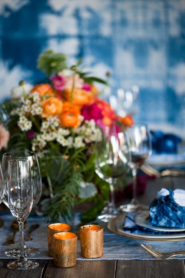 Votives and colourful flowers on wedding table