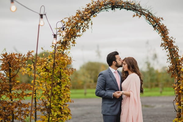 Groom kissing bride's head