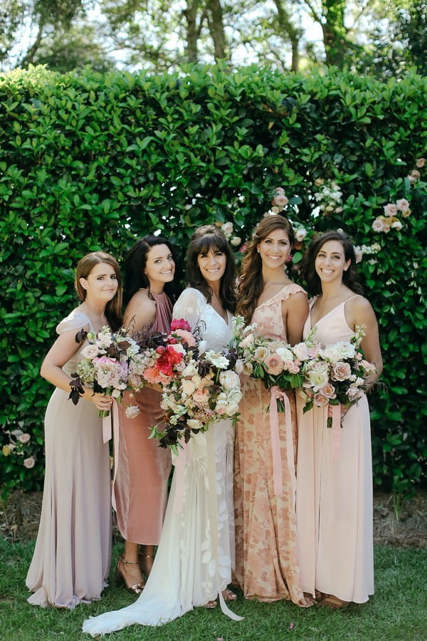Bride with bridesmaids in mismatched dresses