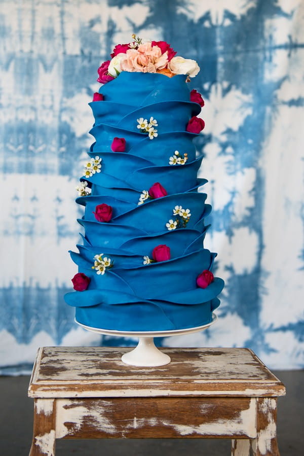 Blue ruffle wedding cake with roses