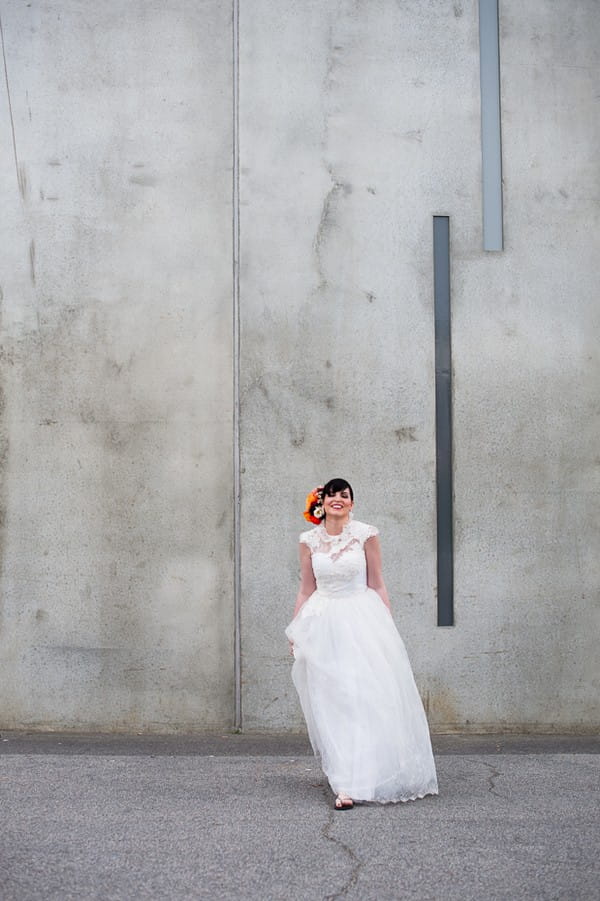 Bride standing in front of grey wall