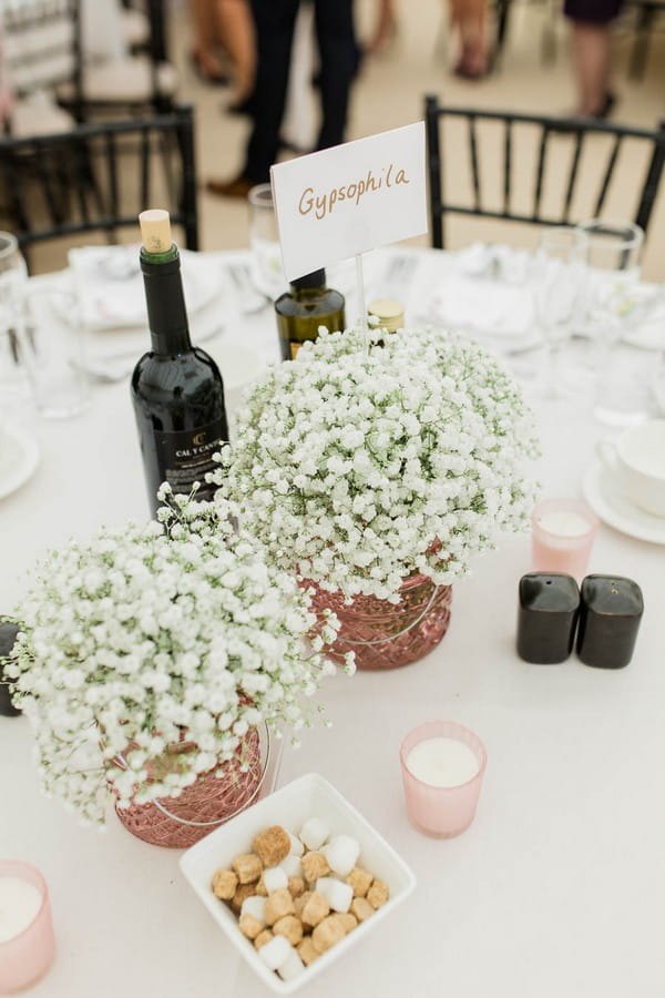 Copper pots of white flowers on wedding table