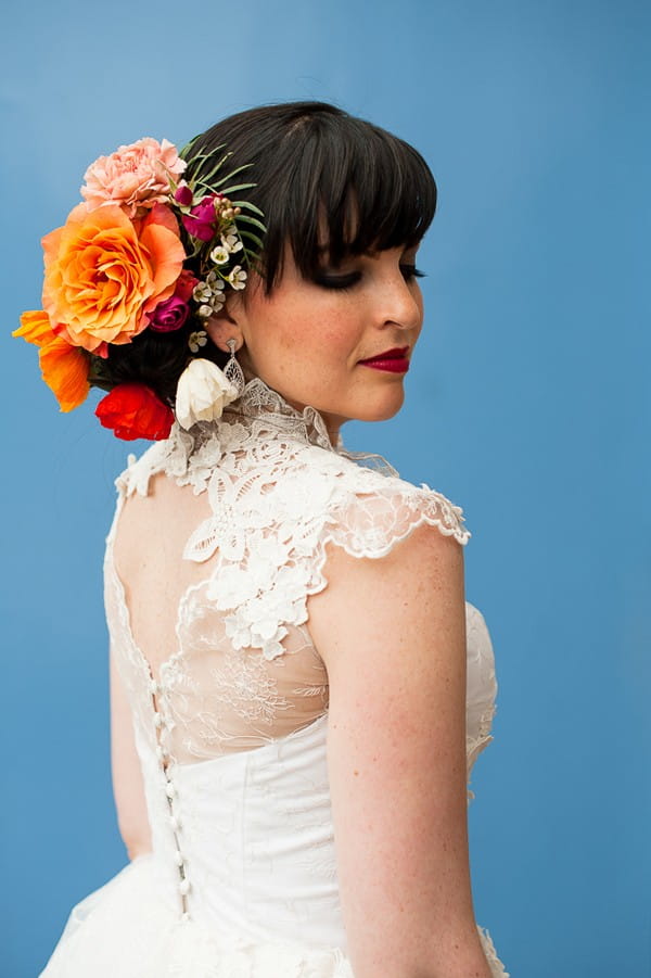 Bride with flowers in hair against indigo backdrop