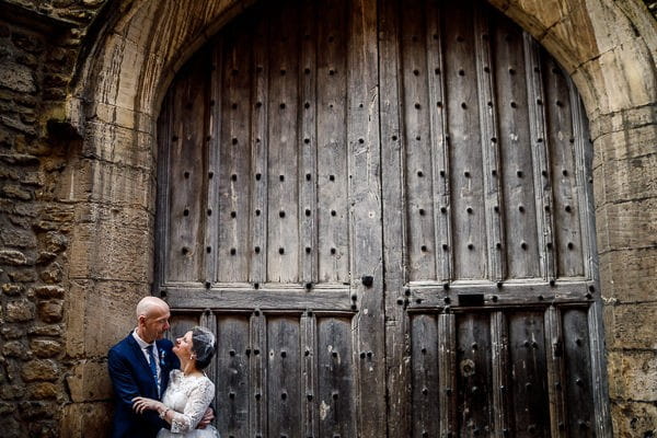 Bride and groom in front of large doors