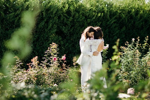 Bride and groom hugging in gardens of Merribee