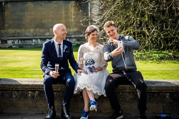 Man talking selfie with bride and groom