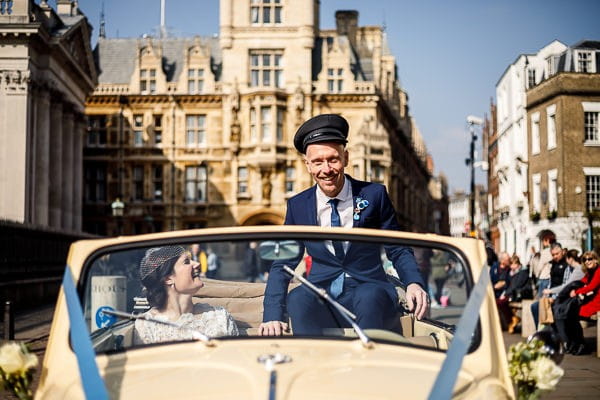 Groom in wedding car wearing driver's hat