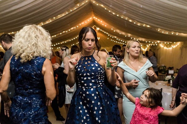 Wedding guests dancing in marquee