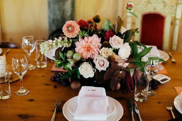 Simple wedding place setting with floral centrepiece
