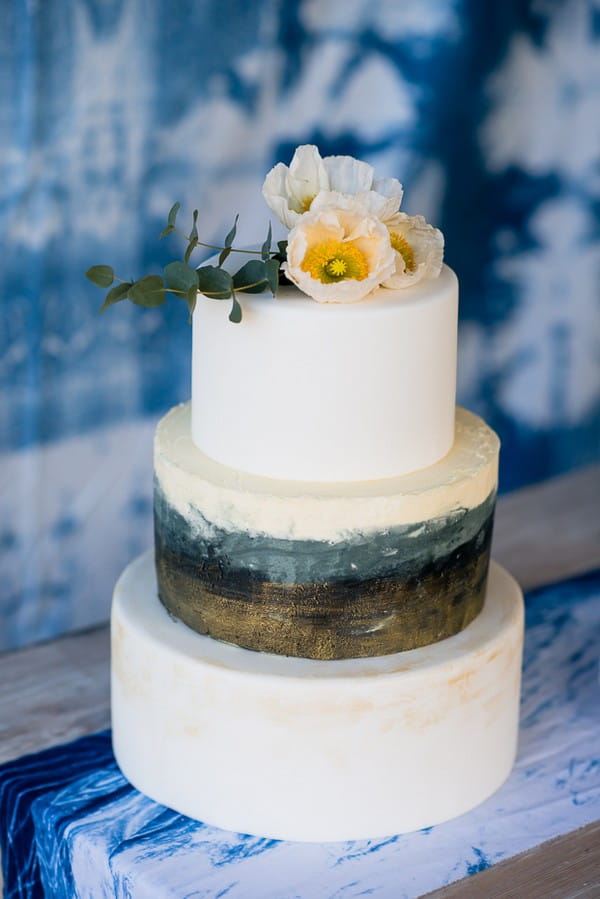 White three-tier wedding cake with watercolour stripe detail