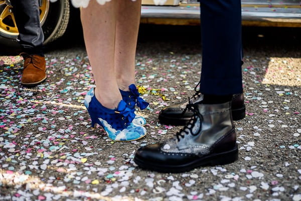 Bride and groom's feet standing in confetti