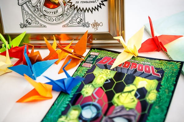 Paper cranes and comic book on wedding table