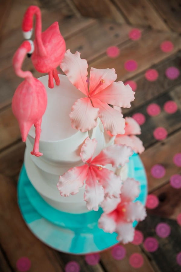 Wedding cake with pink flowers and flamingo topper, made by Claire's Sweet Temptations