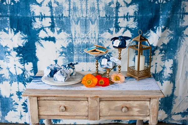 Wedding decorations on dresser in front of indigo Shibori wedding backdrop