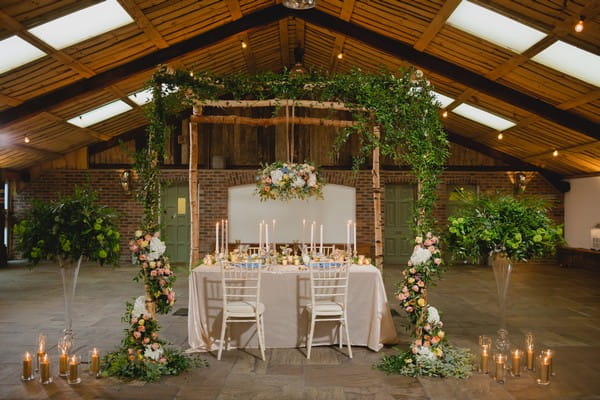 Wedding table with hanging florals and foliage above