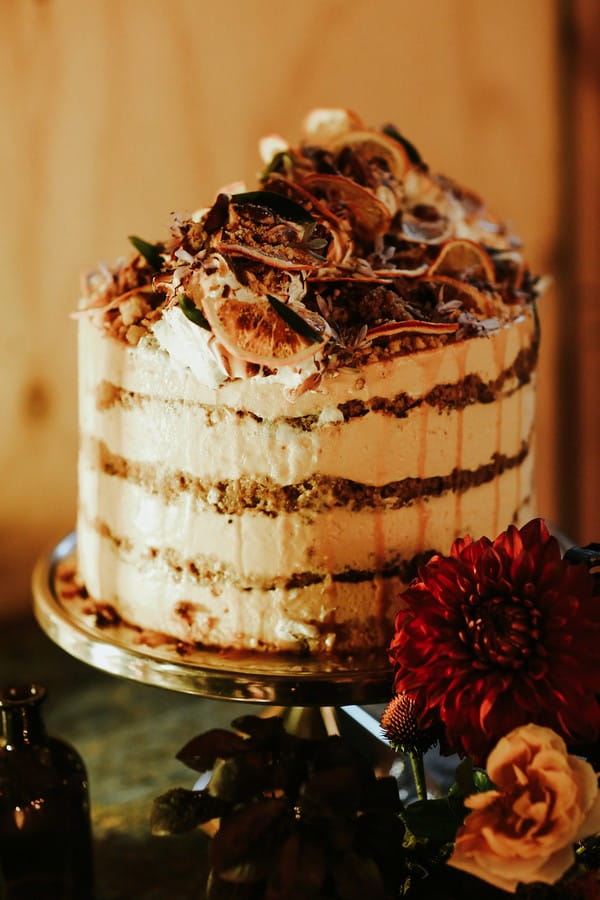 Cream layered wedding cake with orange slice top