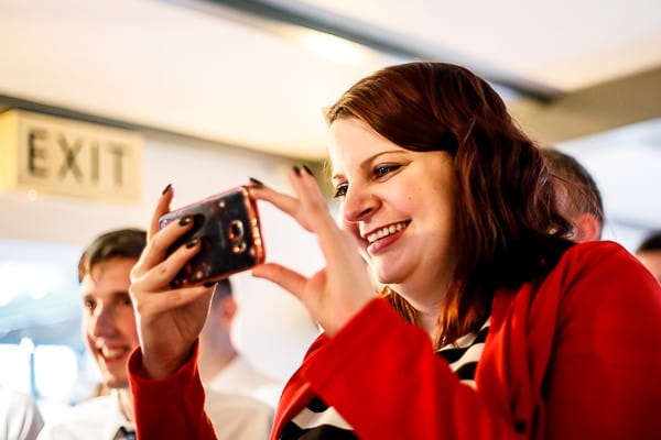 Wedding guest taking picture on phone