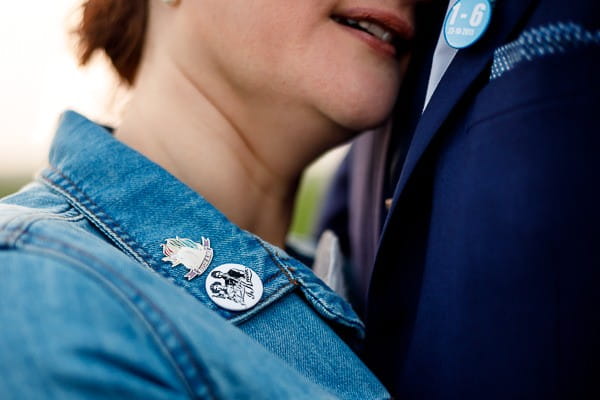 Badges on collar of bride's denim jacket