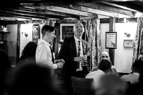 Groom laughing in pub