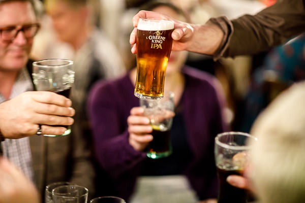 Toasting with pints in pub