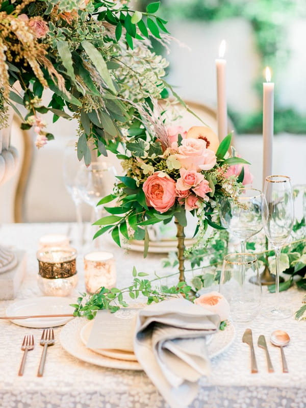 Wedding place setting with peach coloured flowers