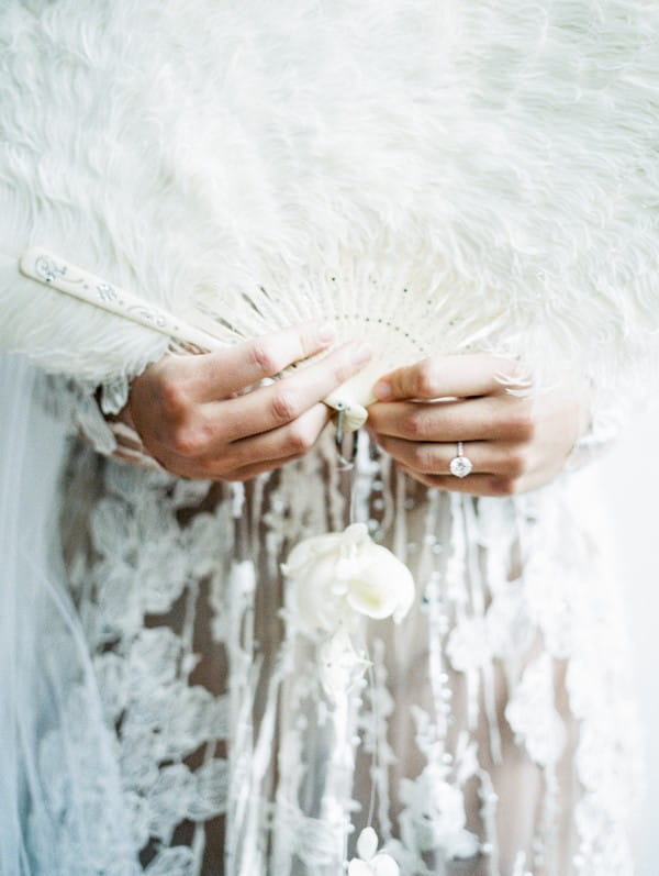 Feather fan in bride's hands