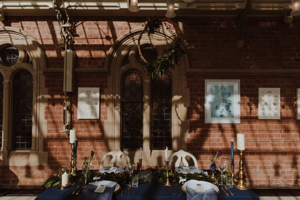 Foliage wreath hanging above wedding table