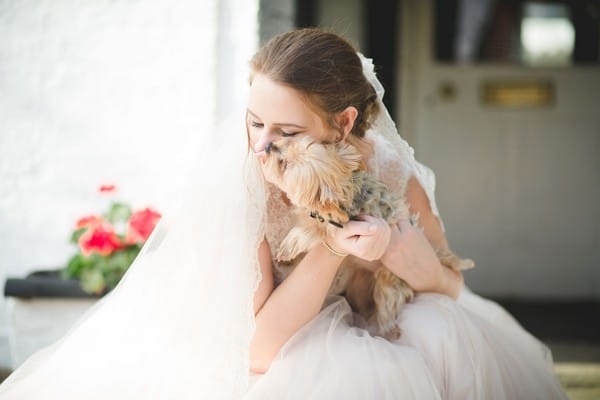 Bride cuddling small dog - Picture by Ella Parkinson Photography