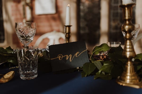 Dark blue hand lettering wedding table number