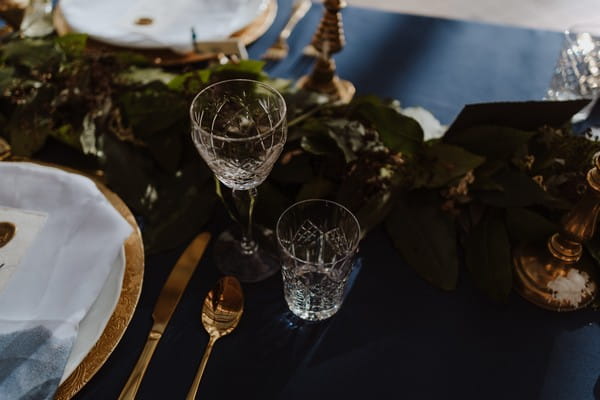 Glasses on wedding table with dark blue tablecloth